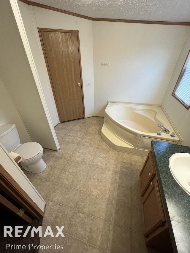 bathroom with toilet, crown molding, a textured ceiling, vanity, and a washtub