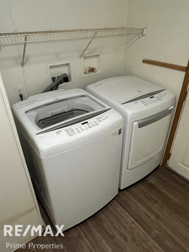 washroom with dark hardwood / wood-style floors and washing machine and clothes dryer