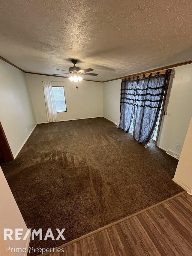 empty room with ornamental molding, dark hardwood / wood-style floors, and ceiling fan