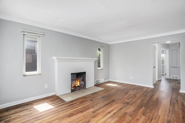 unfurnished living room featuring a fireplace and hardwood / wood-style floors