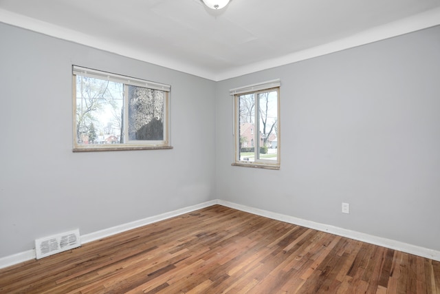 unfurnished room with wood-type flooring