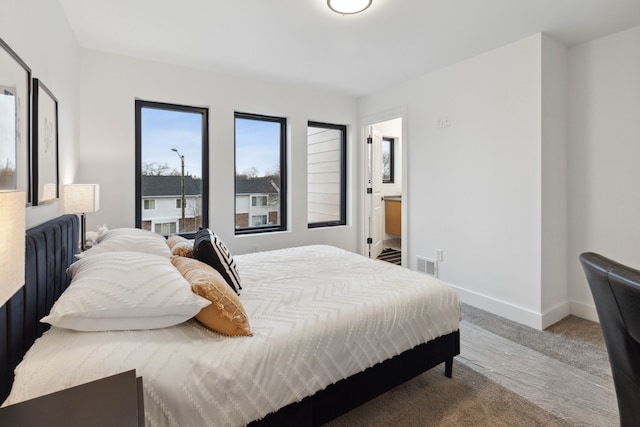 bedroom with carpet floors and ensuite bath