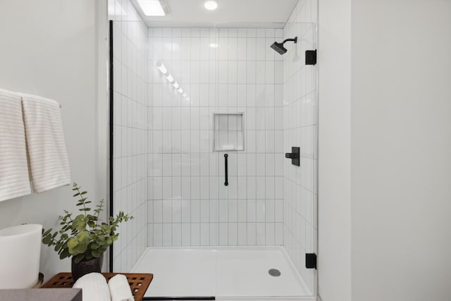 bathroom with a shower with door