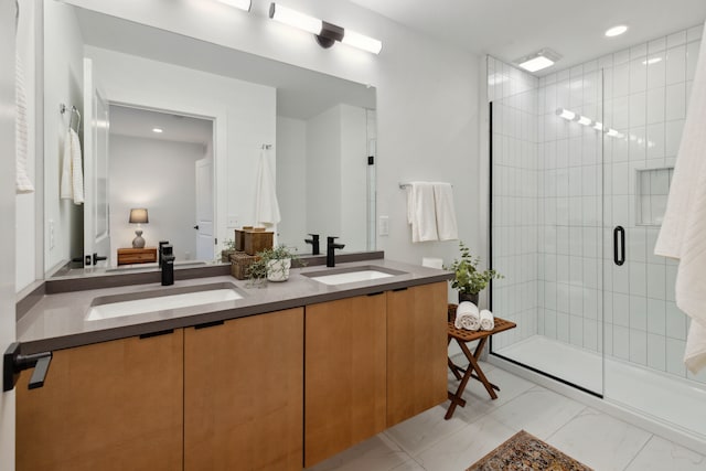 bathroom featuring vanity and an enclosed shower