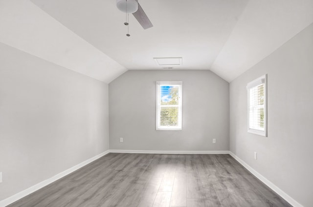 bonus room with hardwood / wood-style floors, ceiling fan, and vaulted ceiling