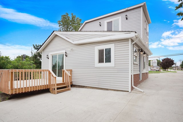 back of house featuring a patio area and a wooden deck