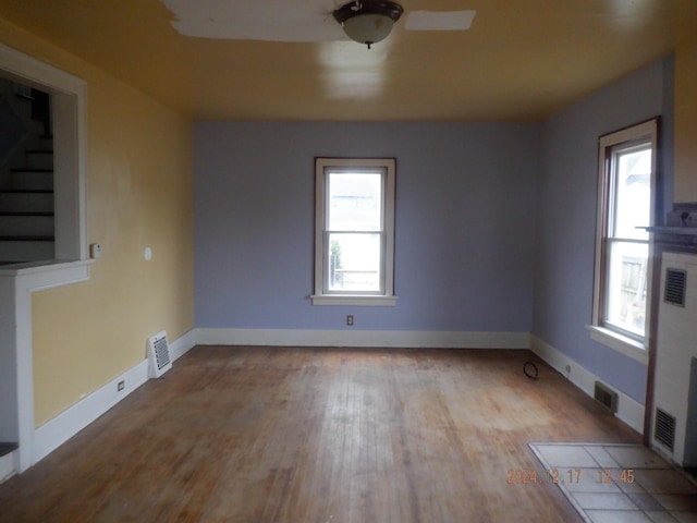 unfurnished room featuring a wealth of natural light and light wood-type flooring