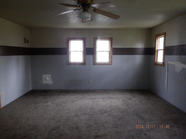 unfurnished room with carpet flooring, a textured ceiling, and ceiling fan