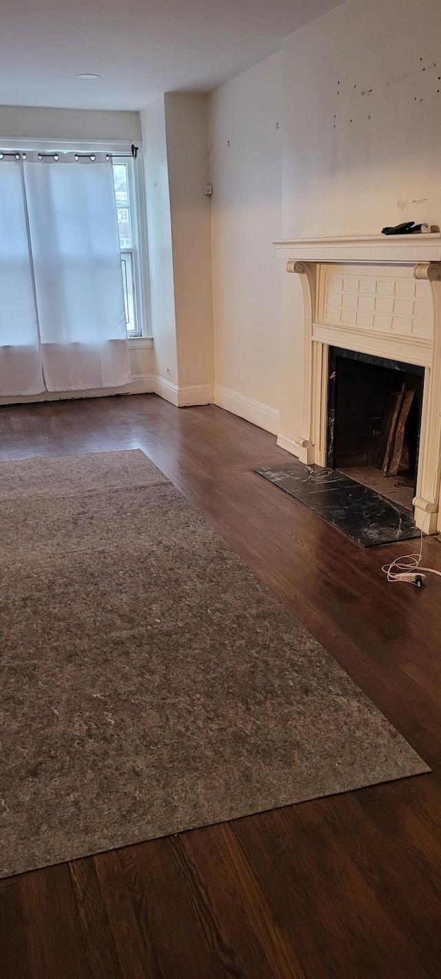 unfurnished living room with dark hardwood / wood-style floors