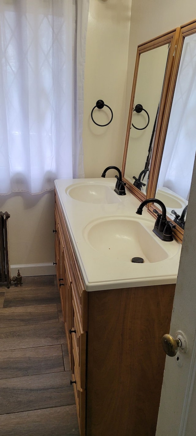 bathroom featuring hardwood / wood-style flooring and vanity