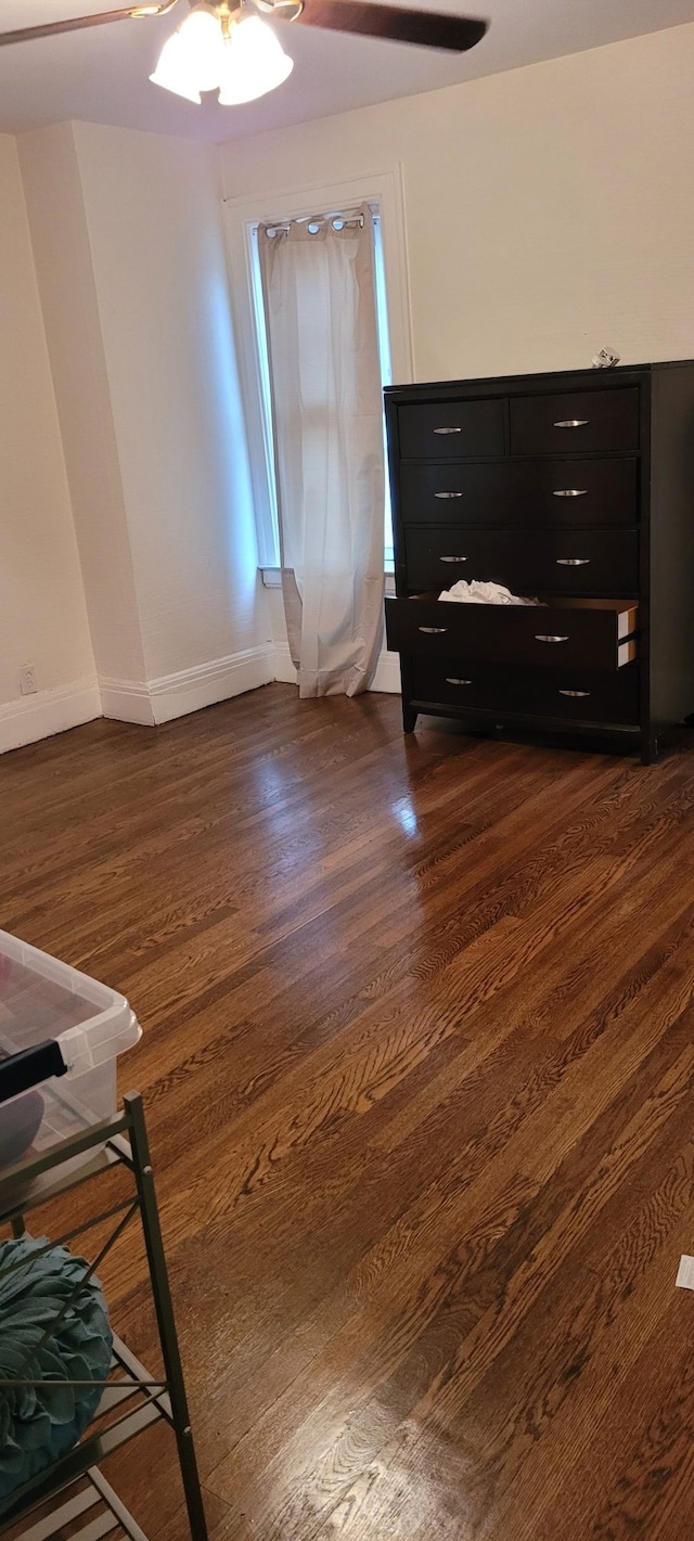 bedroom featuring dark hardwood / wood-style flooring and ceiling fan