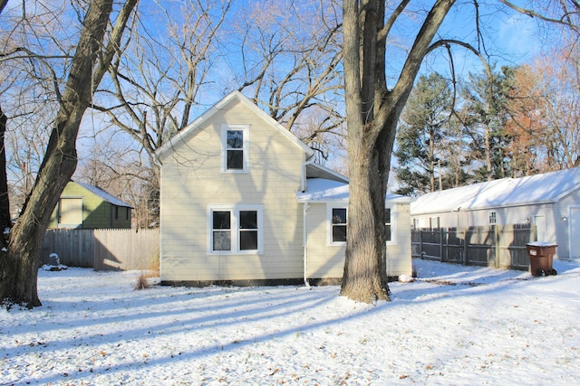 view of snow covered back of property