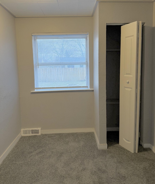 unfurnished bedroom featuring carpet and a closet