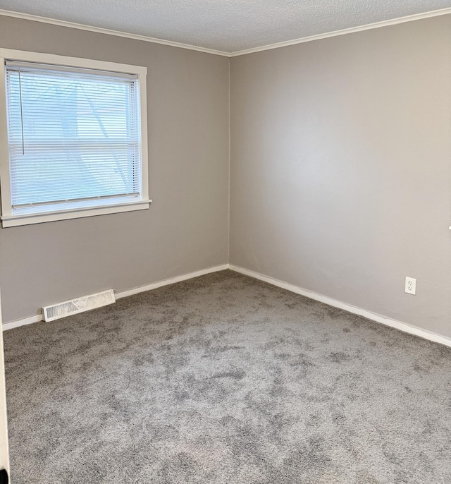 unfurnished room featuring carpet flooring, ornamental molding, and a textured ceiling