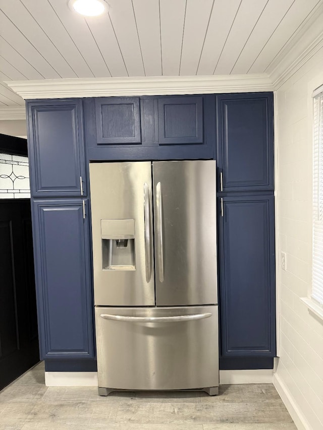 kitchen featuring stainless steel fridge, crown molding, light hardwood / wood-style floors, and blue cabinets