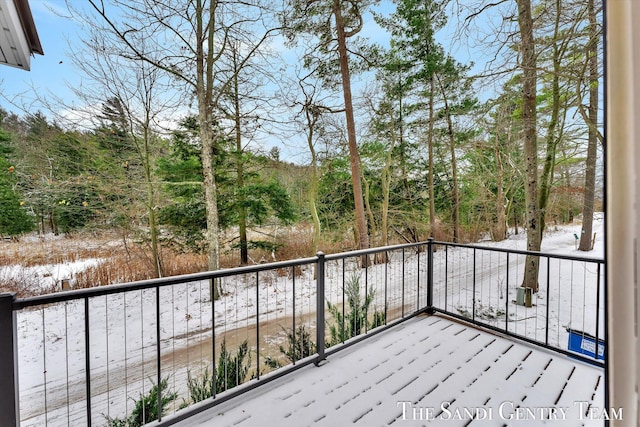 view of snow covered back of property