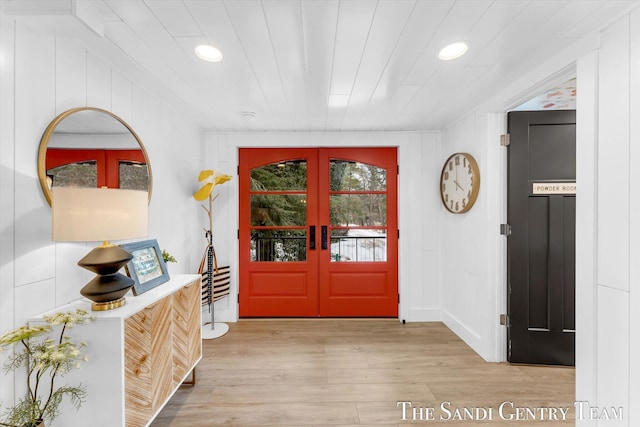 entrance foyer with french doors, light hardwood / wood-style flooring, and wooden ceiling