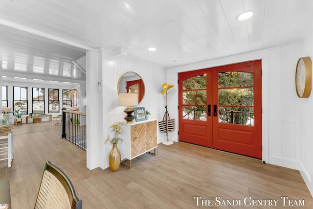 foyer entrance featuring french doors and light hardwood / wood-style flooring