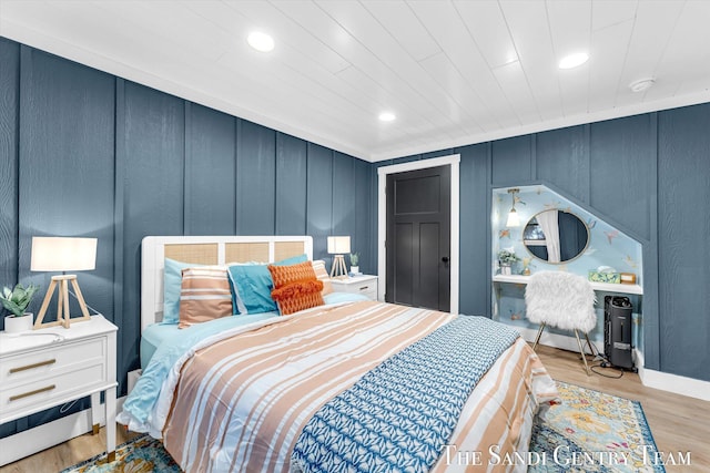 bedroom with ornamental molding and light wood-type flooring