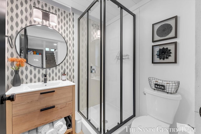 bathroom featuring walk in shower, vanity, decorative backsplash, and toilet