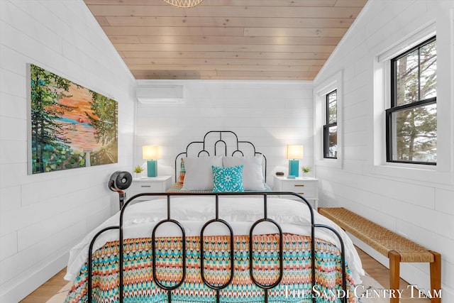 bedroom with lofted ceiling, wood-type flooring, an AC wall unit, and wooden ceiling