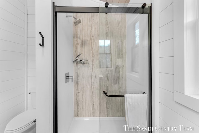 bathroom with toilet and an enclosed shower