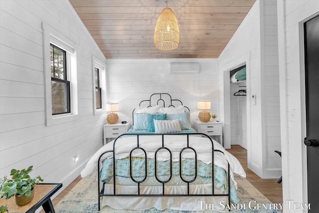 bedroom featuring hardwood / wood-style floors, wooden walls, wooden ceiling, and vaulted ceiling