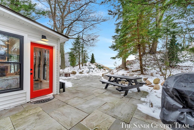 snow covered patio with area for grilling