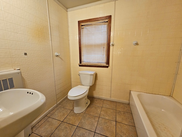 bathroom featuring a washtub, sink, tile walls, tile patterned flooring, and toilet