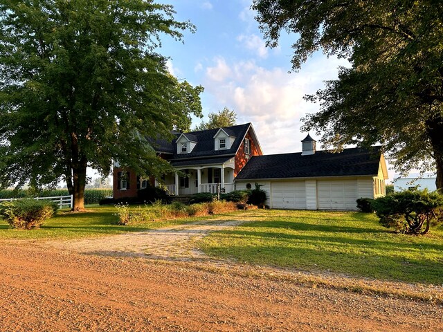 cape cod home featuring a porch, a garage, and a front lawn