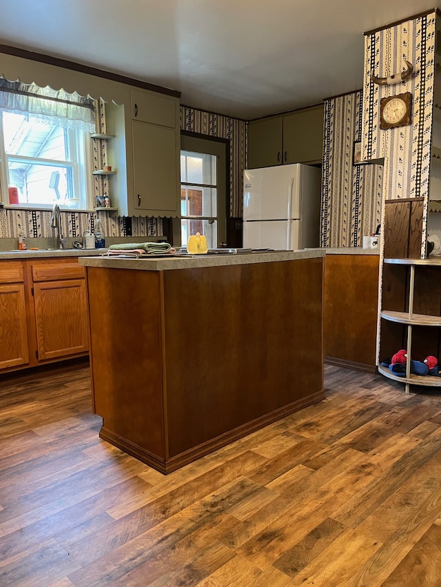 5721 N Rossman Rd W, Kingston, MI 48741 - kitchen with freestanding refrigerator, dark wood-style floors, and plenty of natural light