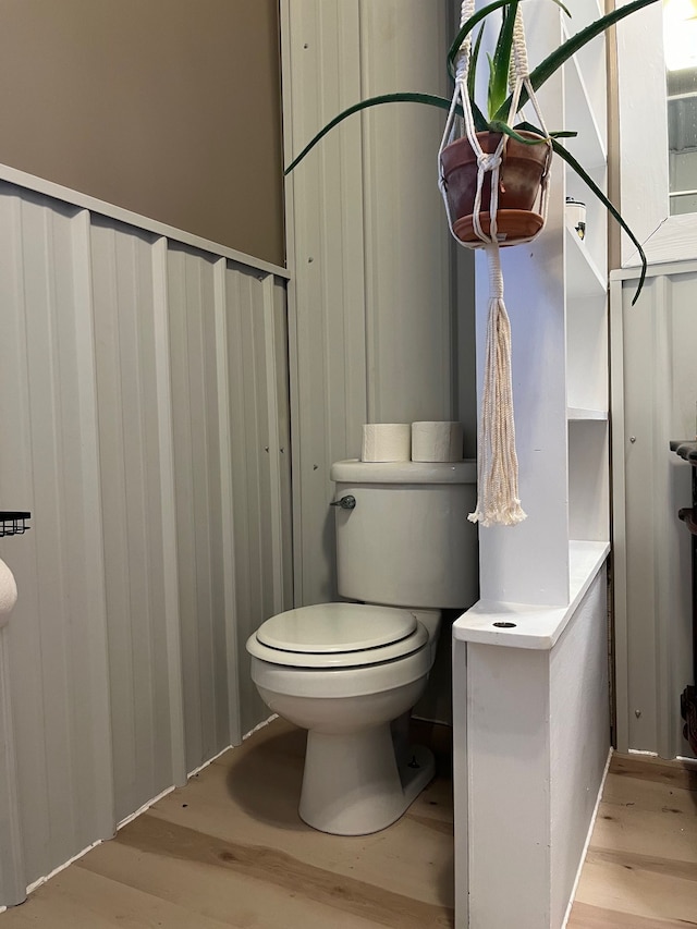 bathroom featuring hardwood / wood-style floors and toilet