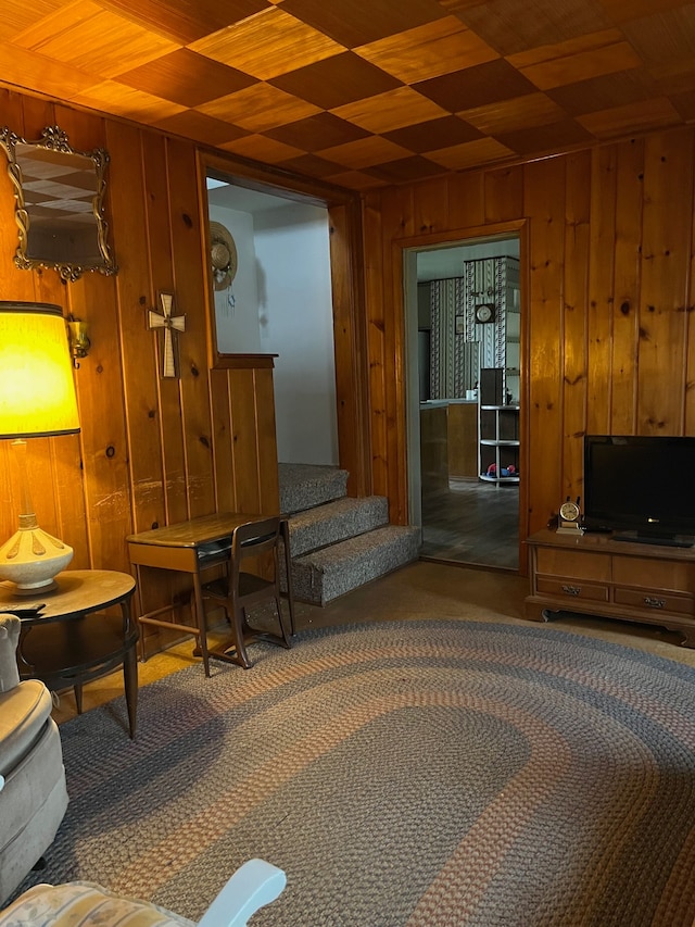 5721 N Rossman Rd W, Kingston, MI 48741 - living room featuring wooden walls, stairway, and carpet floors