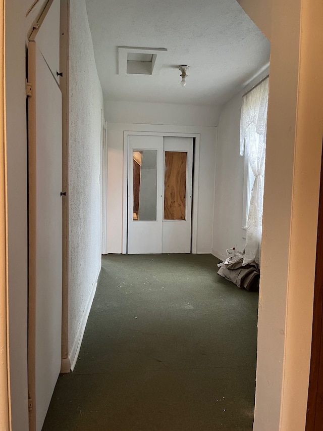 5721 N Rossman Rd W, Kingston, MI 48741 - hallway with carpet flooring and attic access