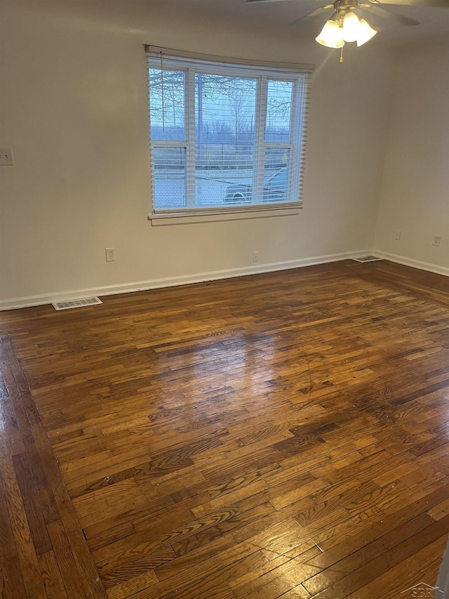 empty room featuring dark hardwood / wood-style floors and ceiling fan