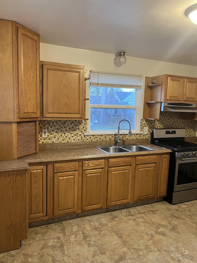 kitchen featuring backsplash, stainless steel gas stove, and sink