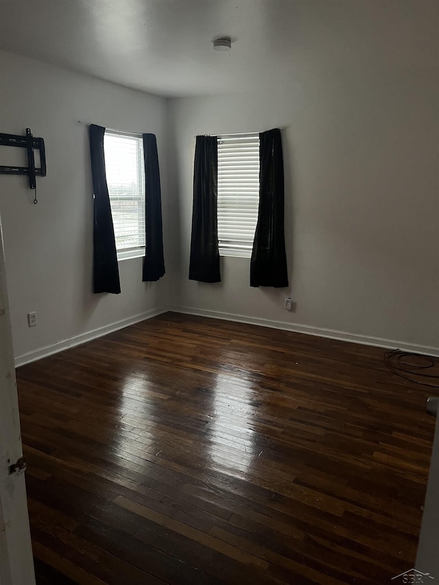 spare room with dark hardwood / wood-style flooring