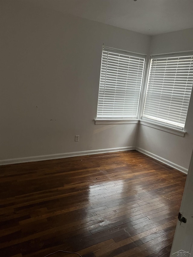 spare room featuring dark hardwood / wood-style flooring