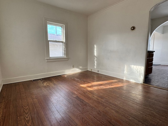 unfurnished room featuring dark hardwood / wood-style floors and crown molding