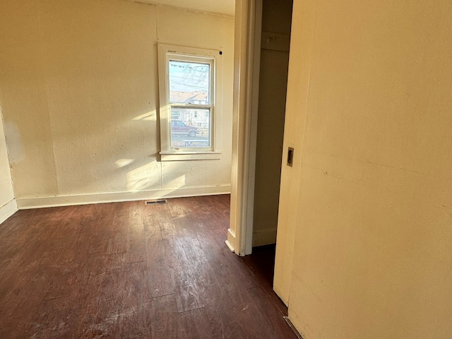 spare room featuring dark hardwood / wood-style flooring