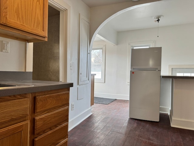 kitchen featuring white refrigerator and dark hardwood / wood-style flooring