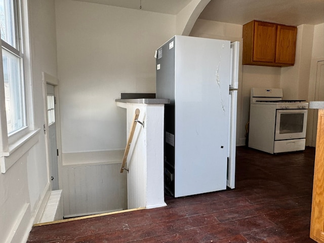 kitchen with dark hardwood / wood-style floors and white appliances