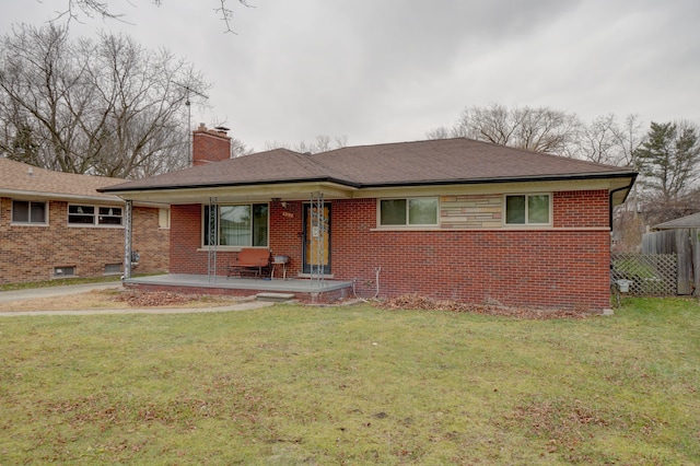 ranch-style home with a front yard and a patio area