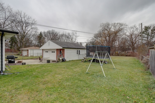 view of yard with an outdoor structure, a patio area, and a trampoline