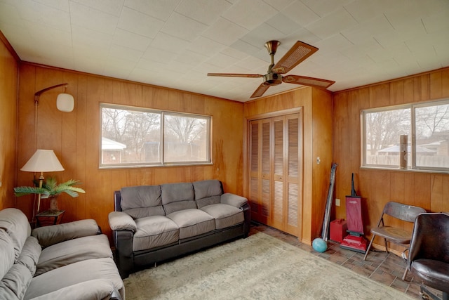 living room with plenty of natural light and wooden walls