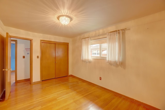 unfurnished bedroom with hardwood / wood-style flooring and a closet