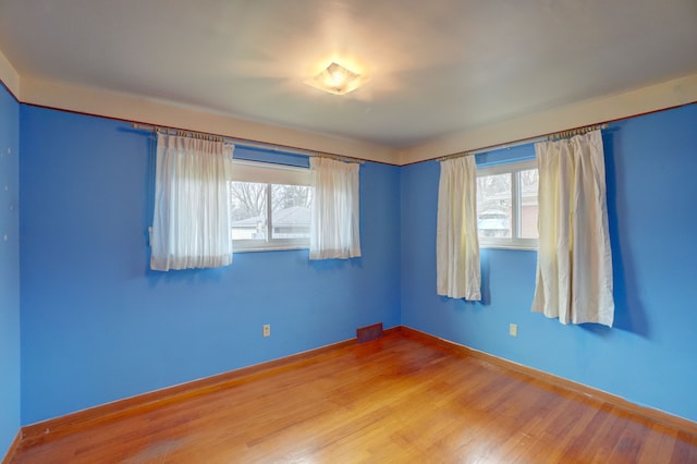 empty room with hardwood / wood-style floors