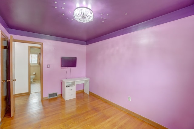 interior space featuring a chandelier and light hardwood / wood-style floors