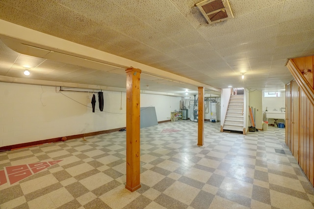 basement with gas water heater and sink