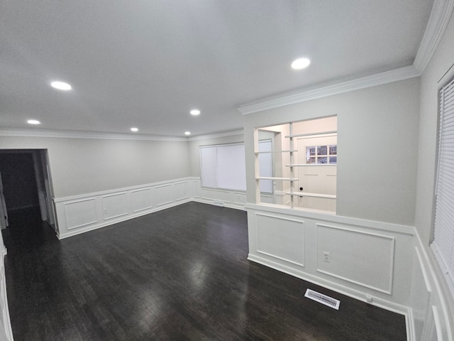 spare room featuring dark hardwood / wood-style flooring and ornamental molding